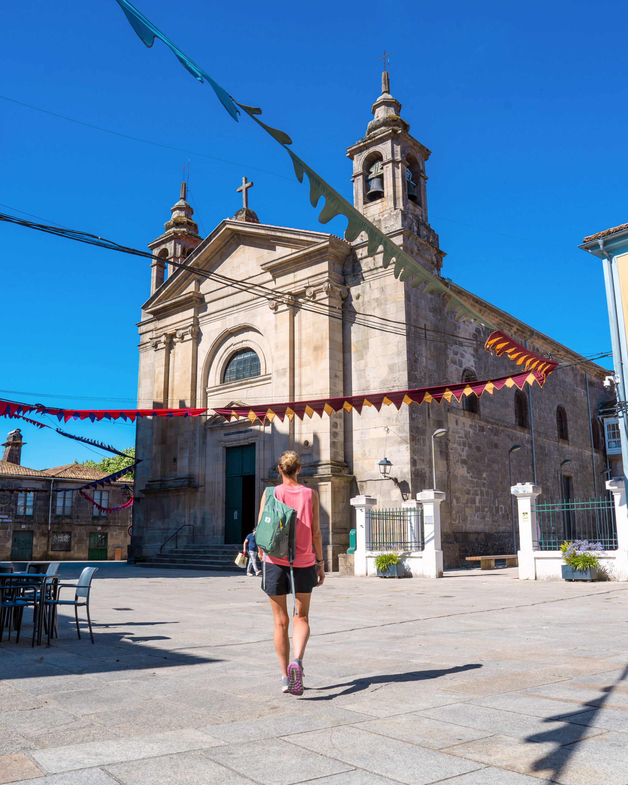 Woman walking towards cathedral in Padron, Spain